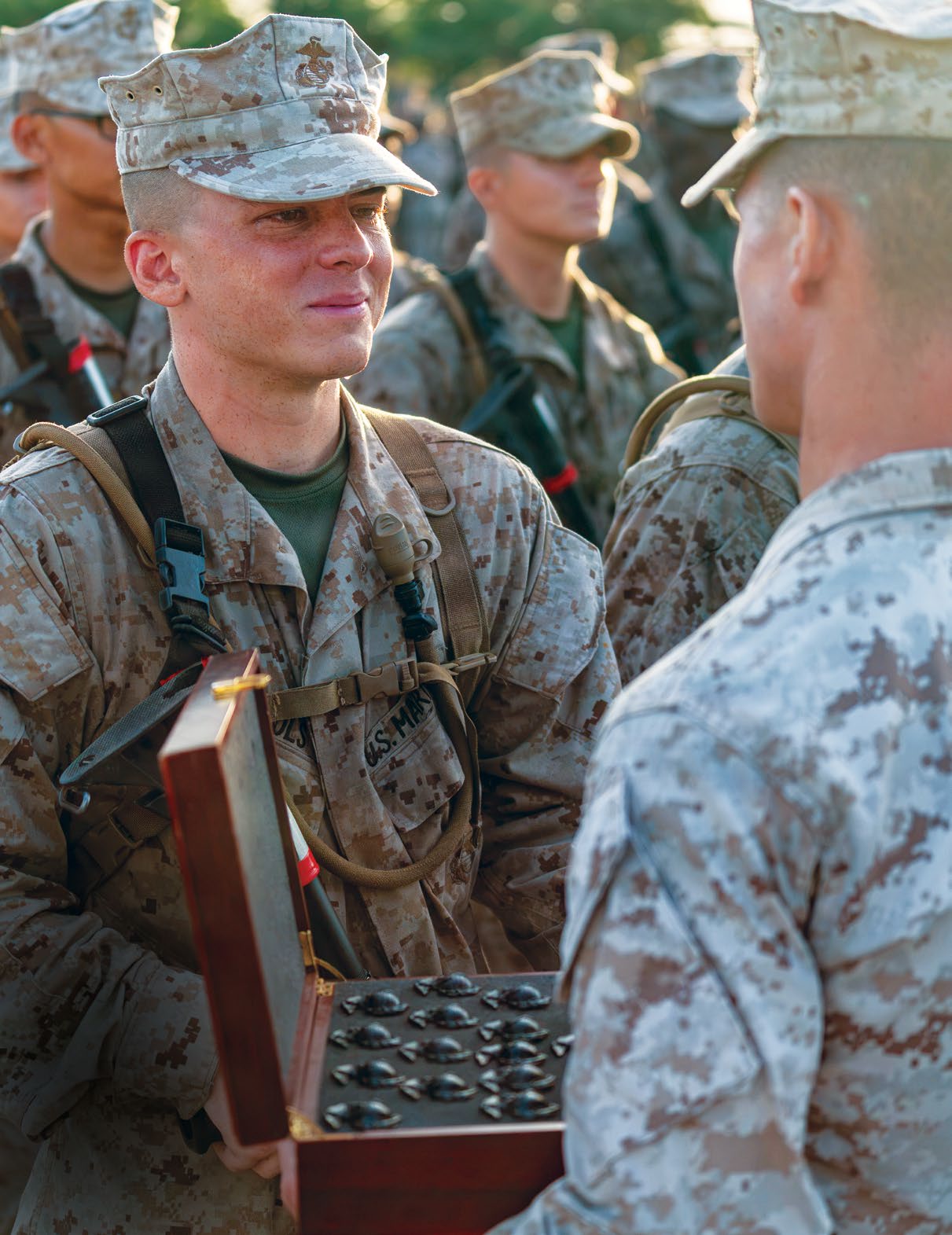 A new U.S. Marine with Alpha Company, 1st Recruit Training Battalion, Recruit Training Regiment, receives his Eagle, Globe, and Anchor (EGA) on Marine Corps Recruit Depot Parris Island, SC, July 11, 2026. Following a culminating 15k hike to the parade deck, recruits are given their EGA and officially become United States Marines. (U.S. Marine Corps photo by Cpl. Dylan Smith))